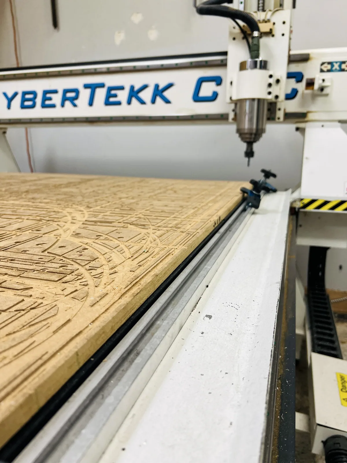 CNC router cutting a wood panel in the GSI shop, from the GSI Google Business Profile