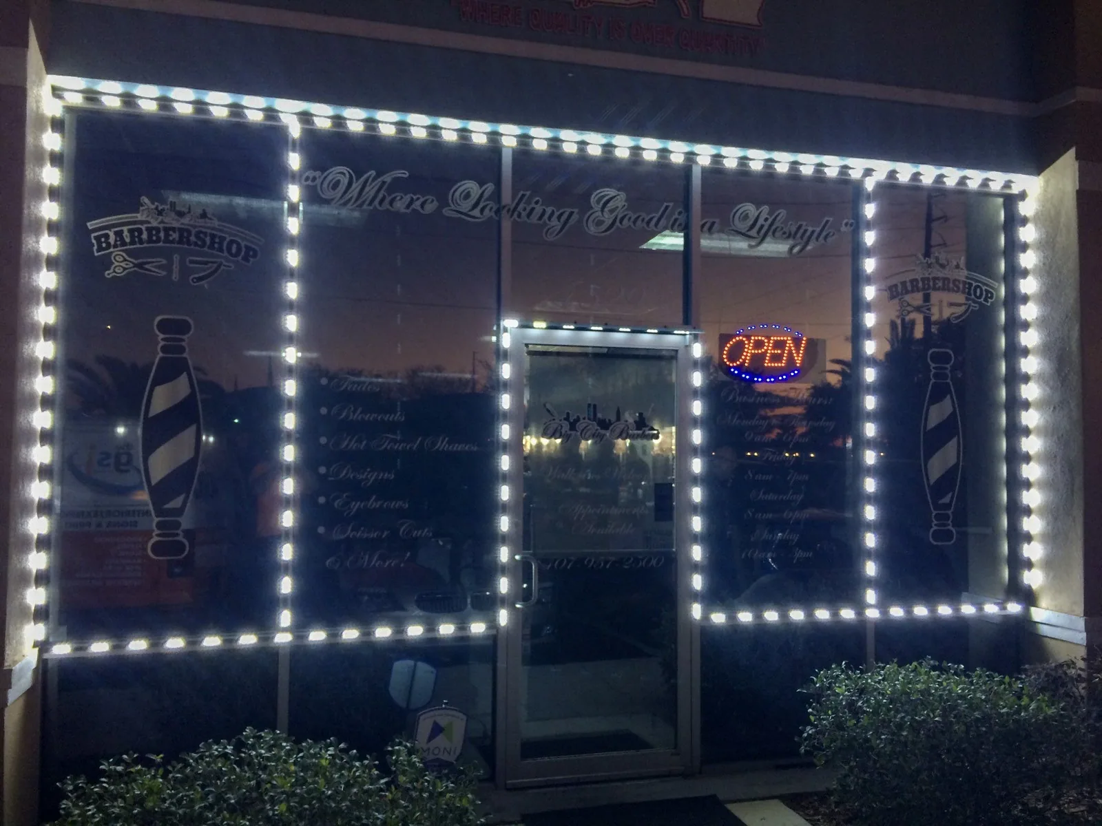 Big City Barbers — Barbershop storefront at night with LED-outlined windows and window graphics, Big City Barbers project