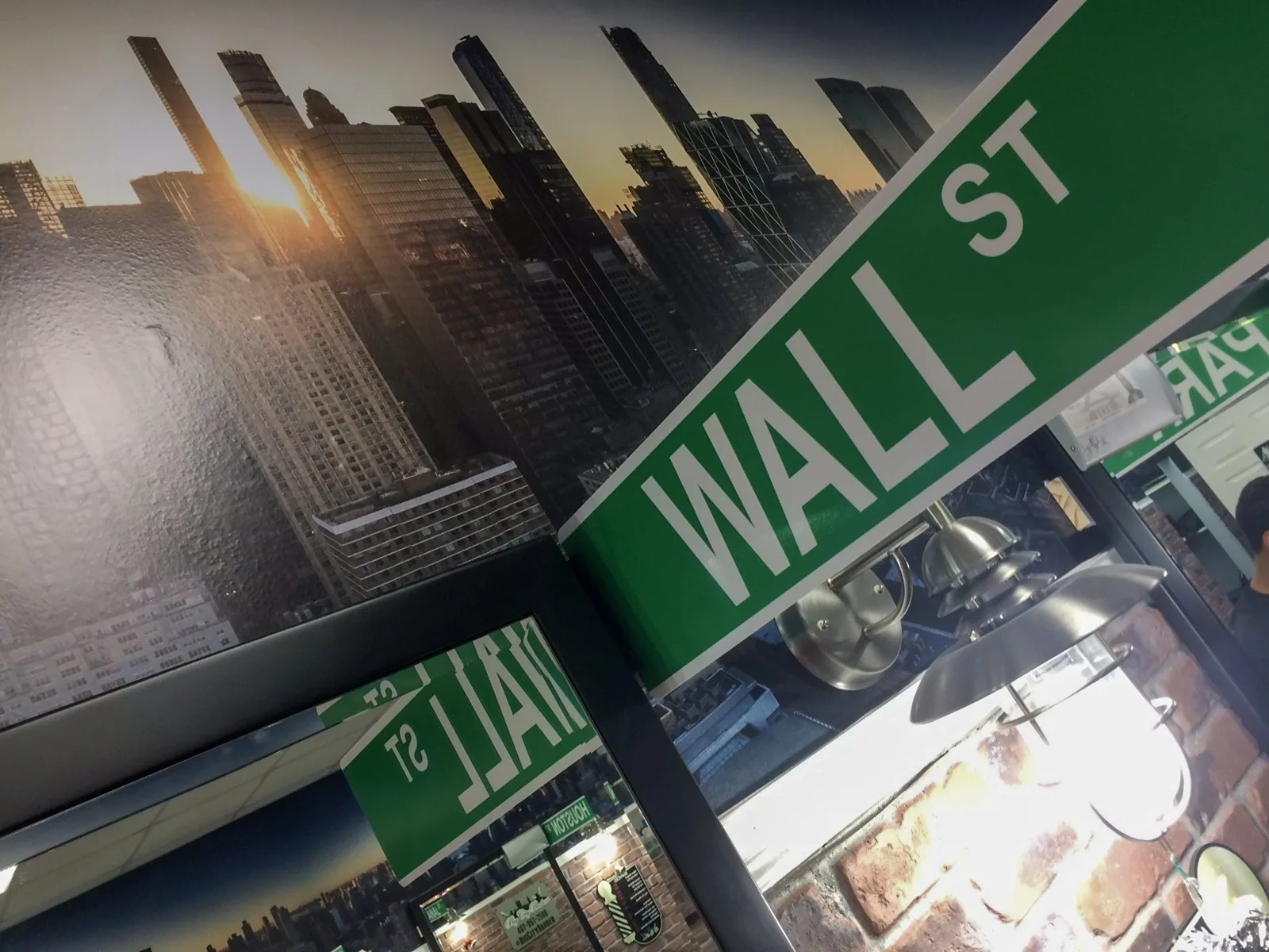 Big City Barbers — Wall St street-name style sign in front of the skyline mural, Big City Barbers project
