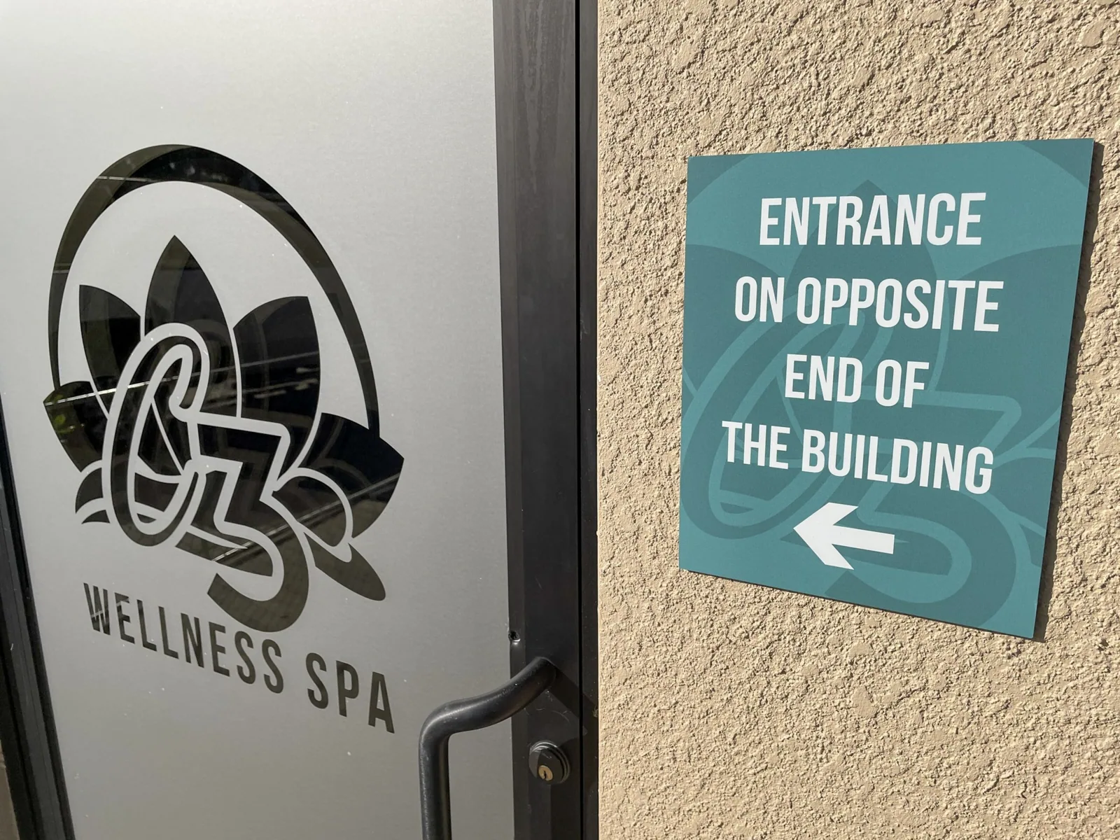 C3 Wellness Spa — C3 Wellness Spa door logo next to a teal Entrance on Opposite End of the Building directional sign, C3 Wellness project