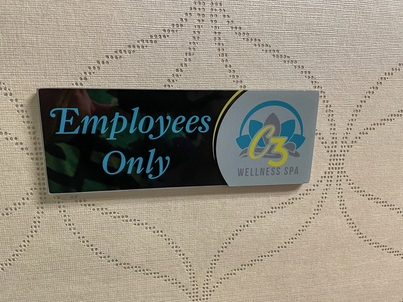 C3 Wellness Spa — Employees Only door plaque with the C3 Wellness Spa logo on a patterned wall, C3 Wellness project