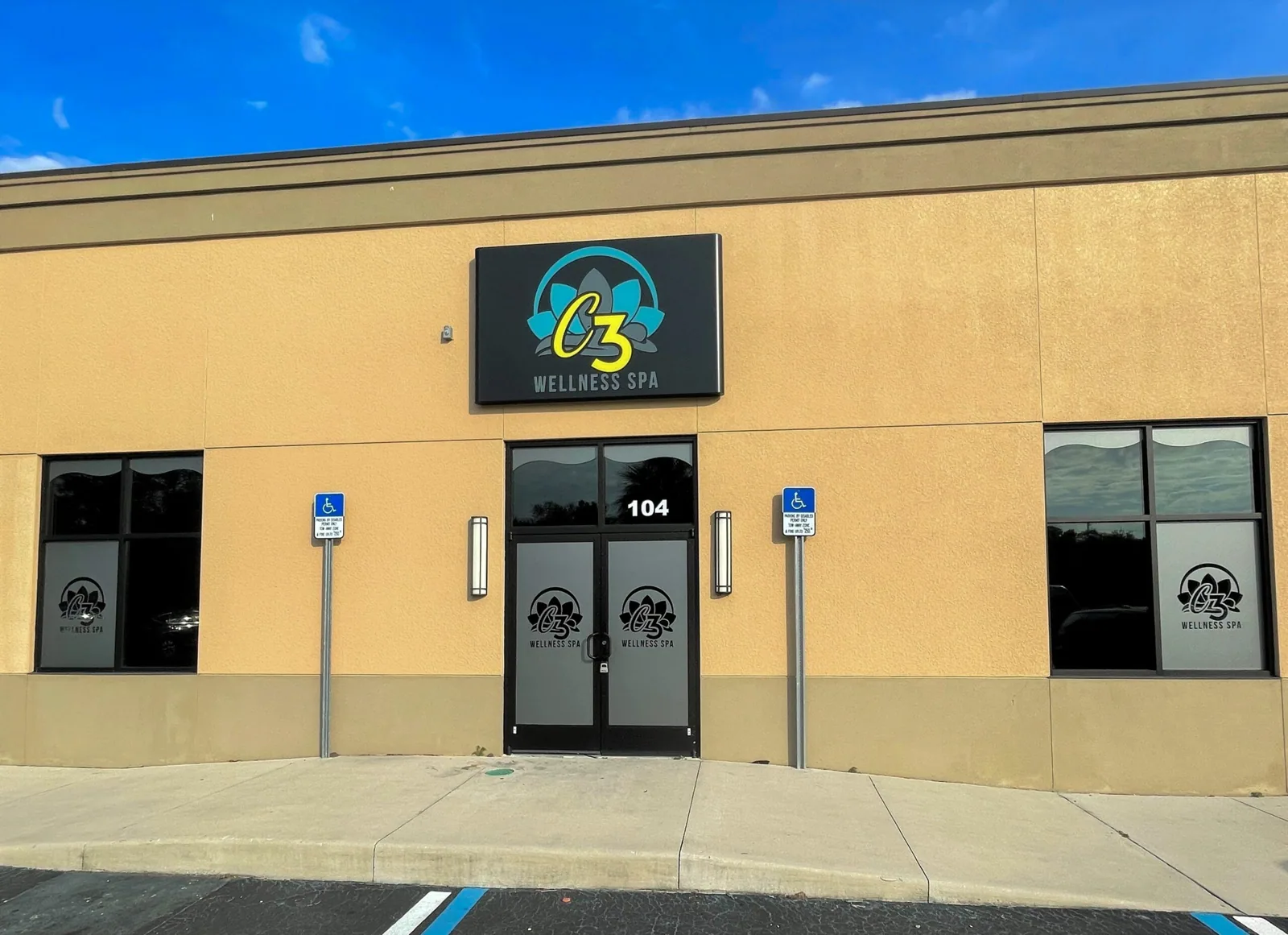 C3 Wellness Spa lit logo sign above a storefront entrance with logo graphics on the windows and doors, C3 Wellness project