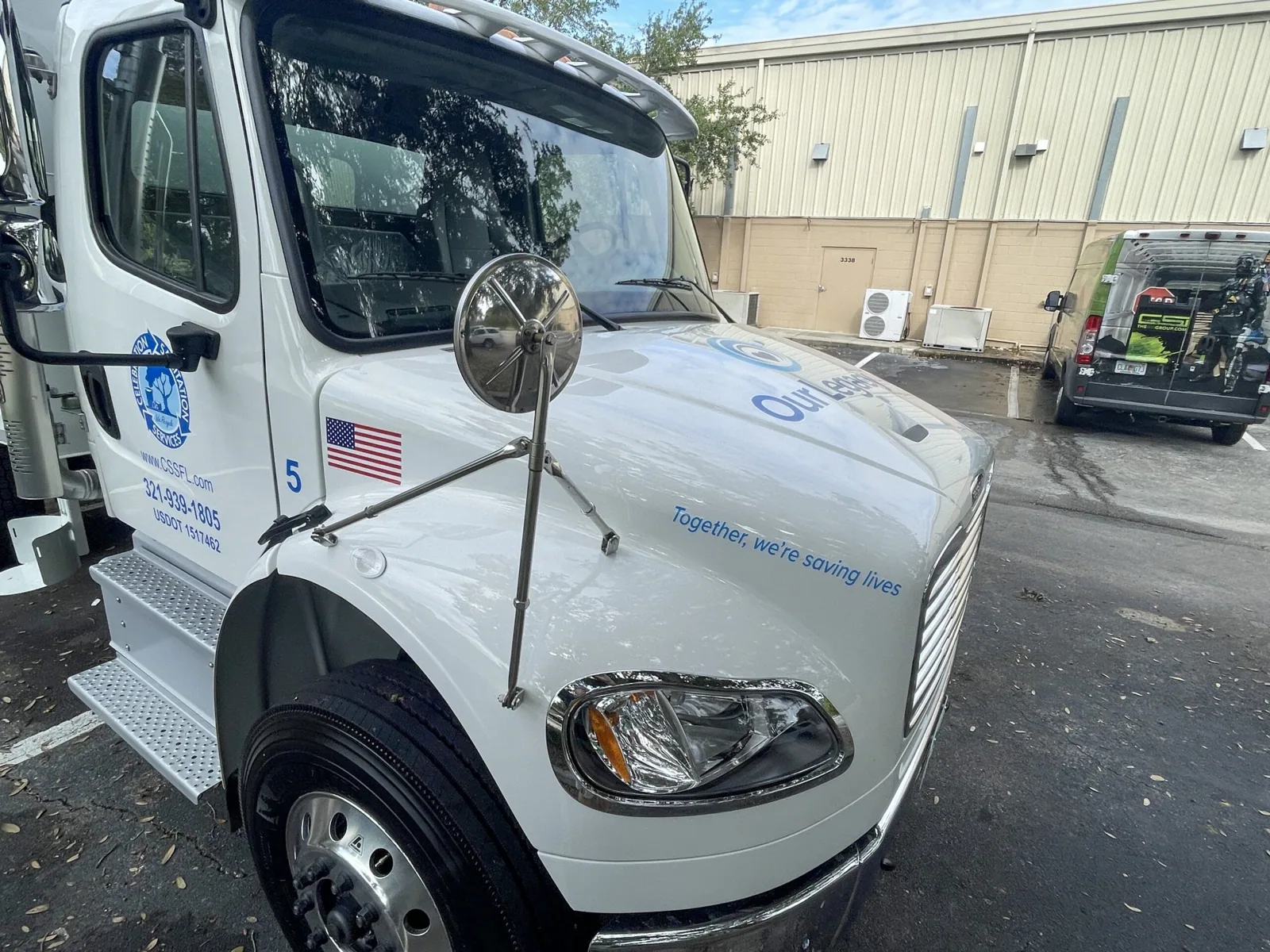 Celebration Sanitation — Truck cab with logo and American flag decals, Celebration Sanitation project