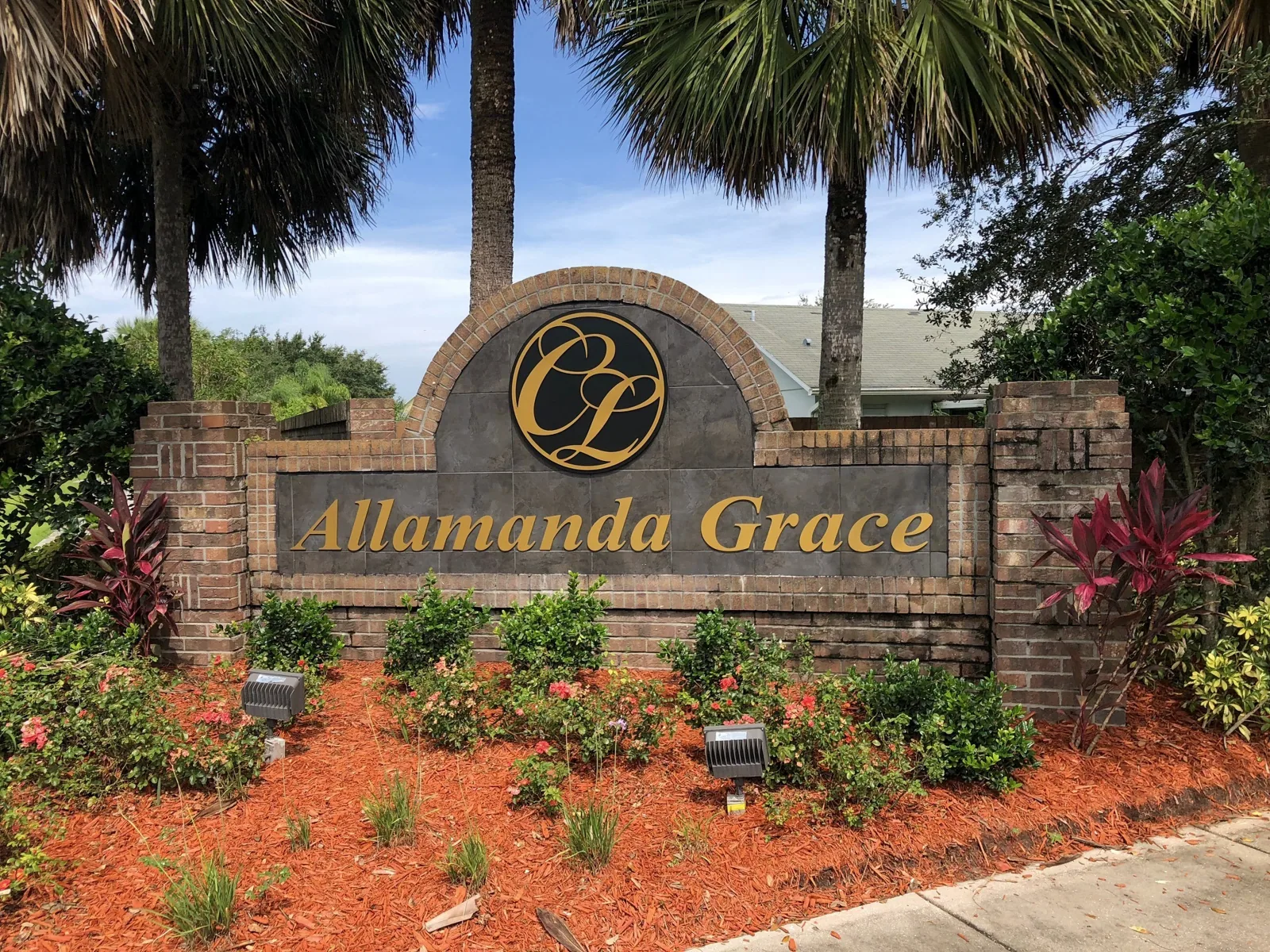 Crescent Lakes — Allamanda Grace brick neighborhood monument sign in a landscaped bed, Crescent Lakes project