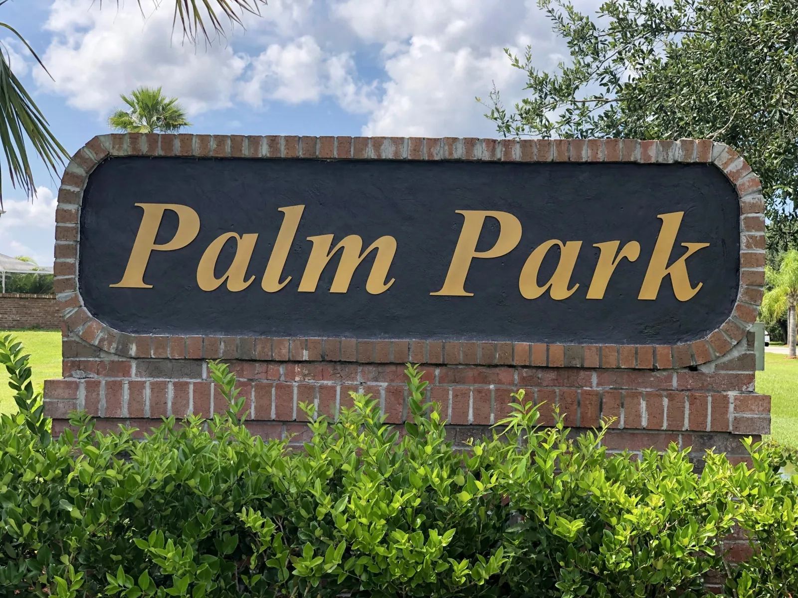 Crescent Lakes — Palm Park brick-framed sign with gold letters, Crescent Lakes project