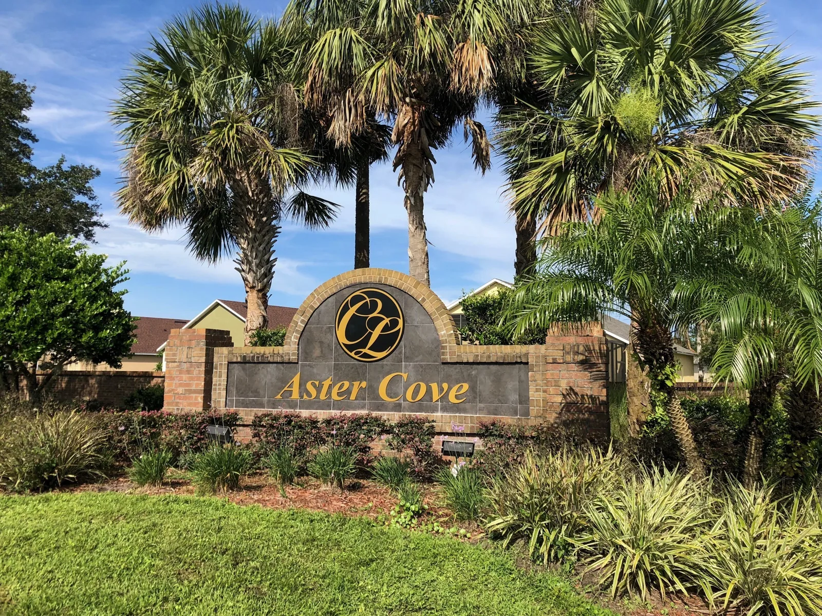 Crescent Lakes — Aster Cove neighborhood monument sign among palm trees, Crescent Lakes project