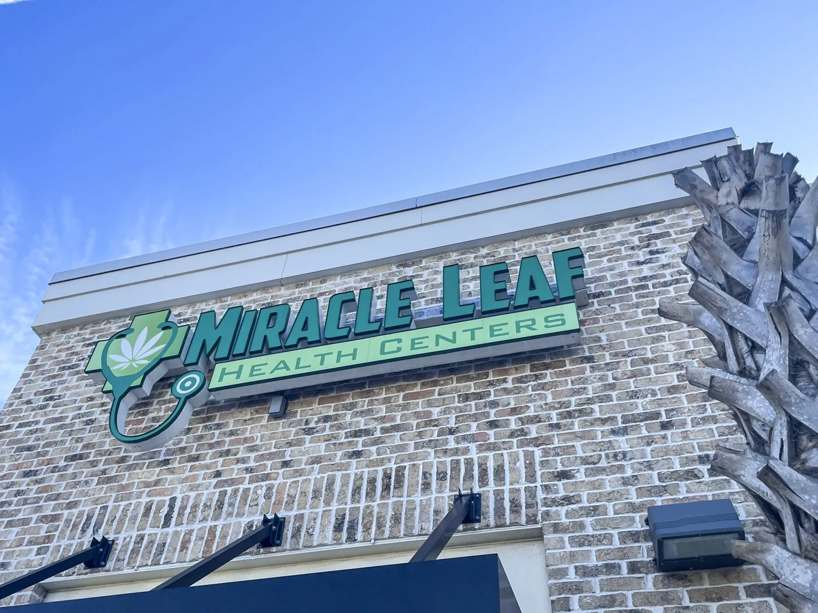 Miracle Leaf Orlando — Angled view of the Miracle Leaf Health Centers sign on a brick facade, Miracle Leaf Orlando project