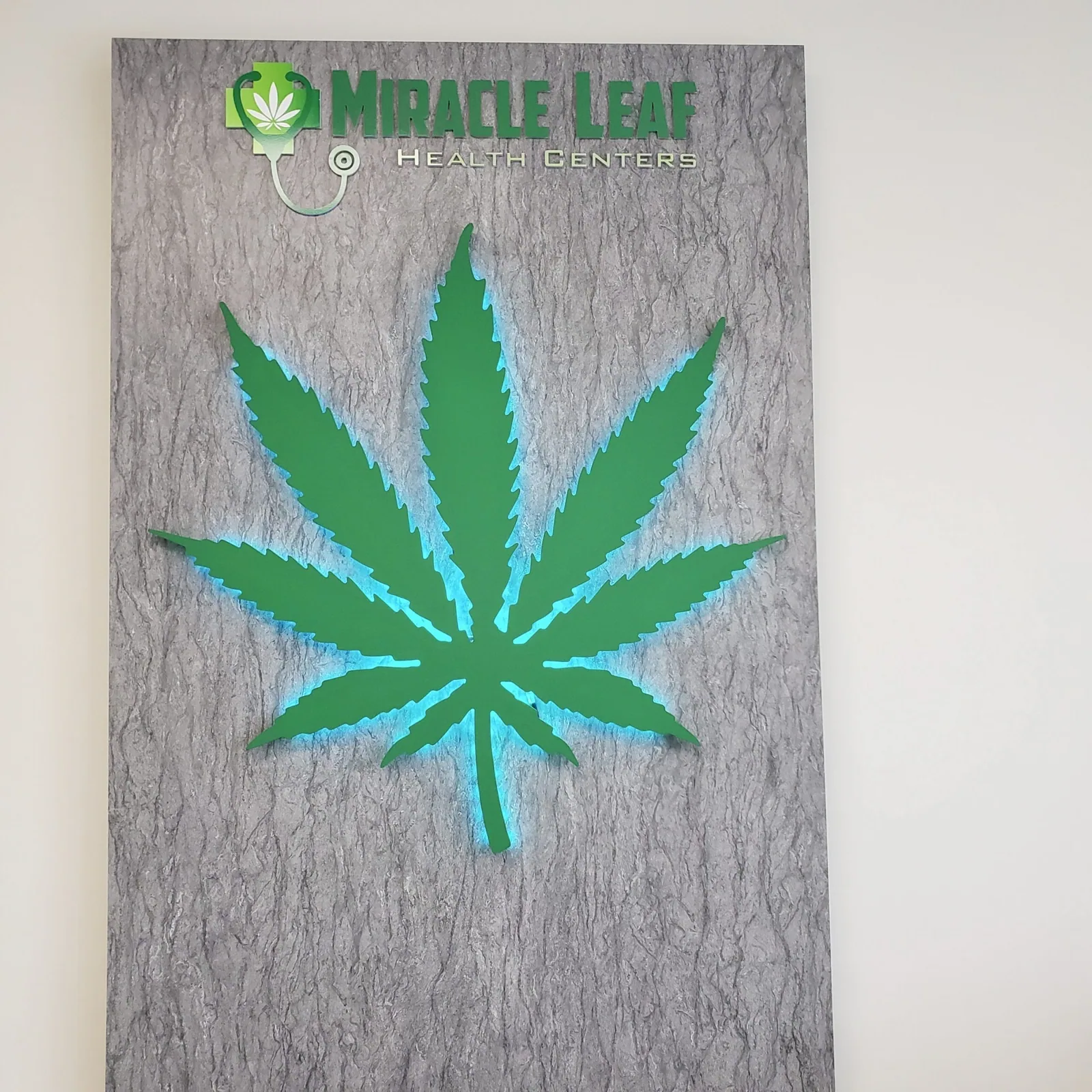 Miracle Leaf Orlando — Leaf logo wall panel with blue edge lighting and Miracle Leaf lettering, Miracle Leaf Orlando project