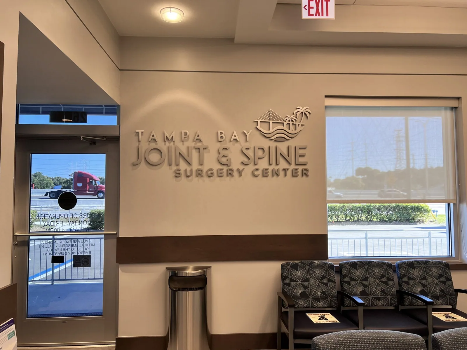 Tampa Bay Joint & Spine — Waiting room with a Tampa Bay Joint & Spine Surgery Center dimensional logo wall, Tampa Bay Joint project