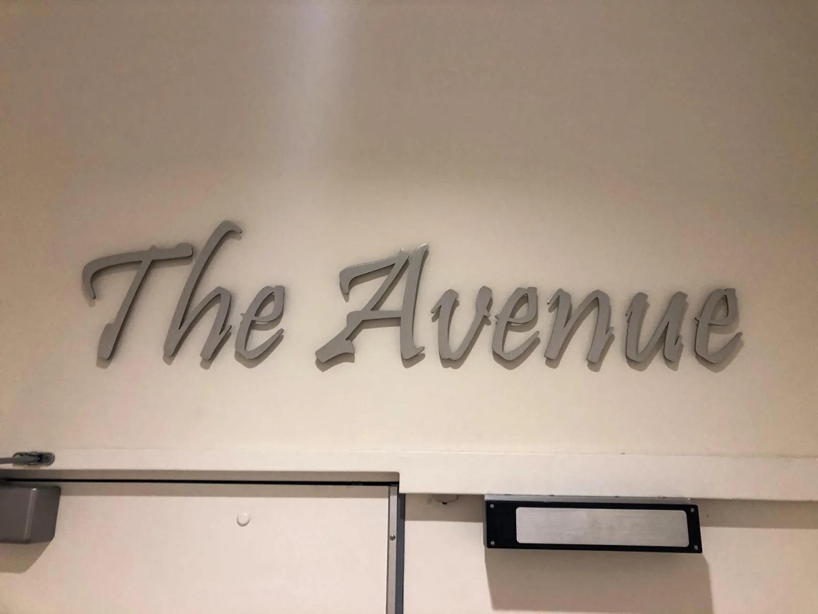 Windsor at Celebration — The Avenue script metal-finish letters on a wall above a doorway, Windsor at Celebration project