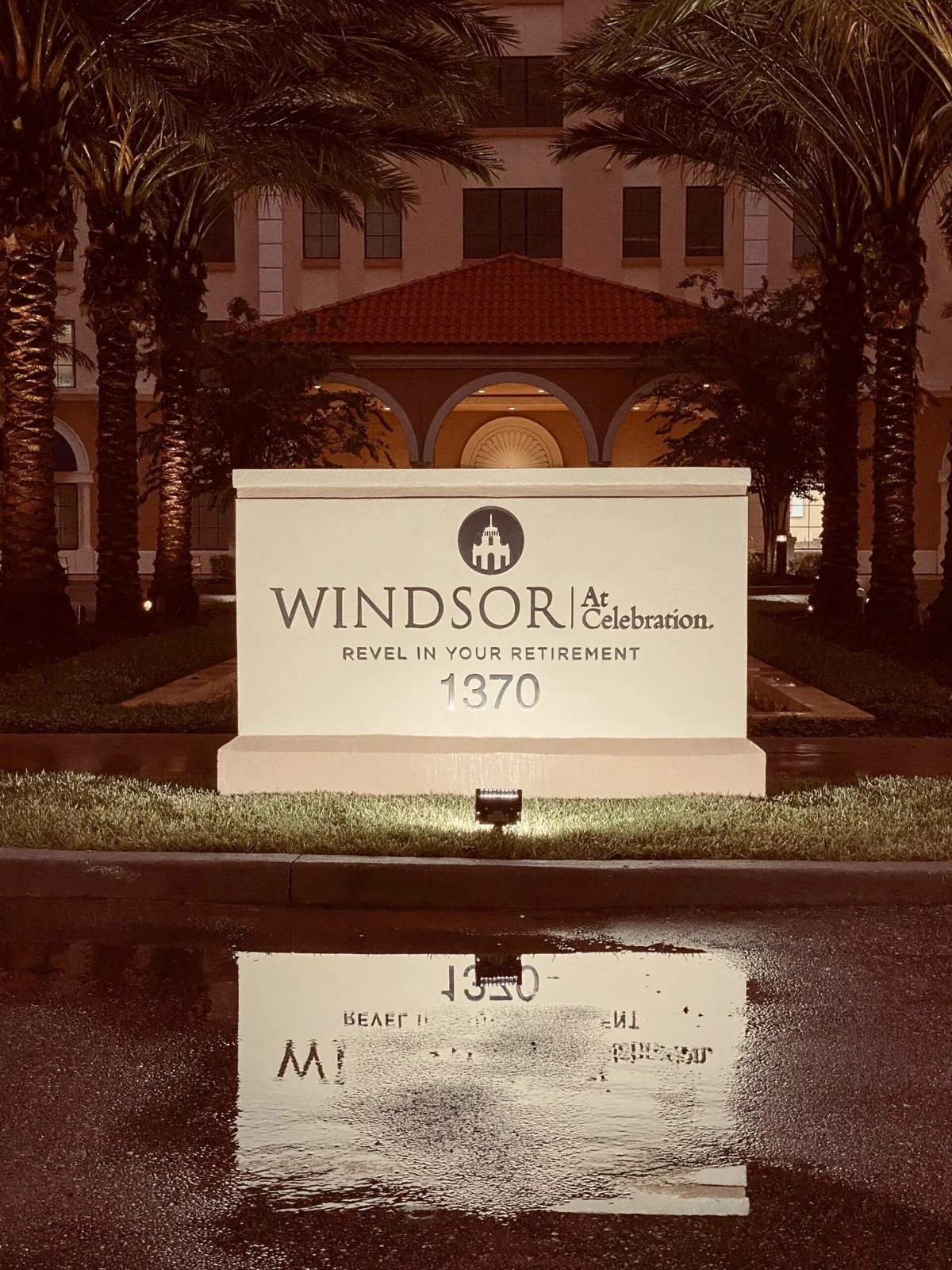 Windsor at Celebration — Illuminated Windsor at Celebration monument sign at night reflected on wet pavement, Windsor at Celebration project