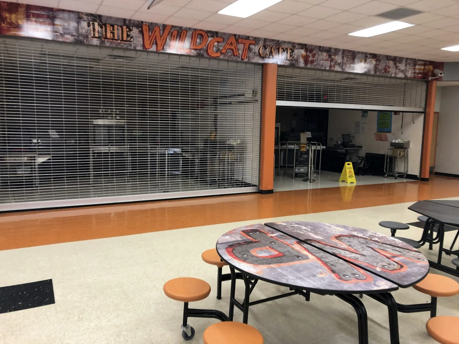 Winter Park High School — Wildcat Cafe header graphic above the serving area and printed cafeteria table tops, Winter Park High School project