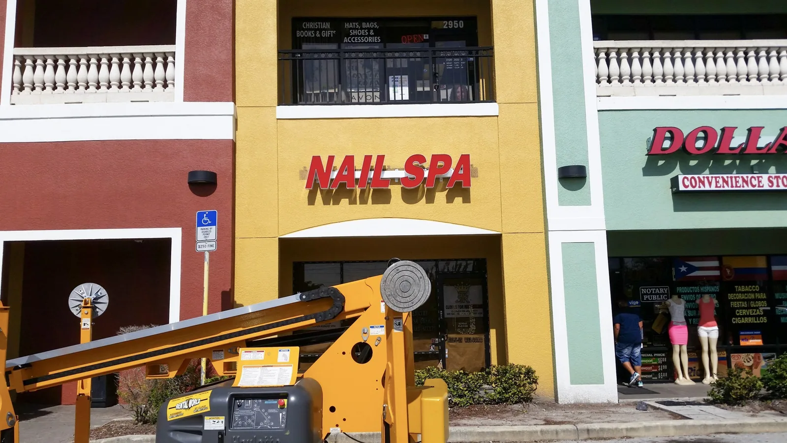 Lift truck in front of a storefront with a Nail Spa channel letter sign