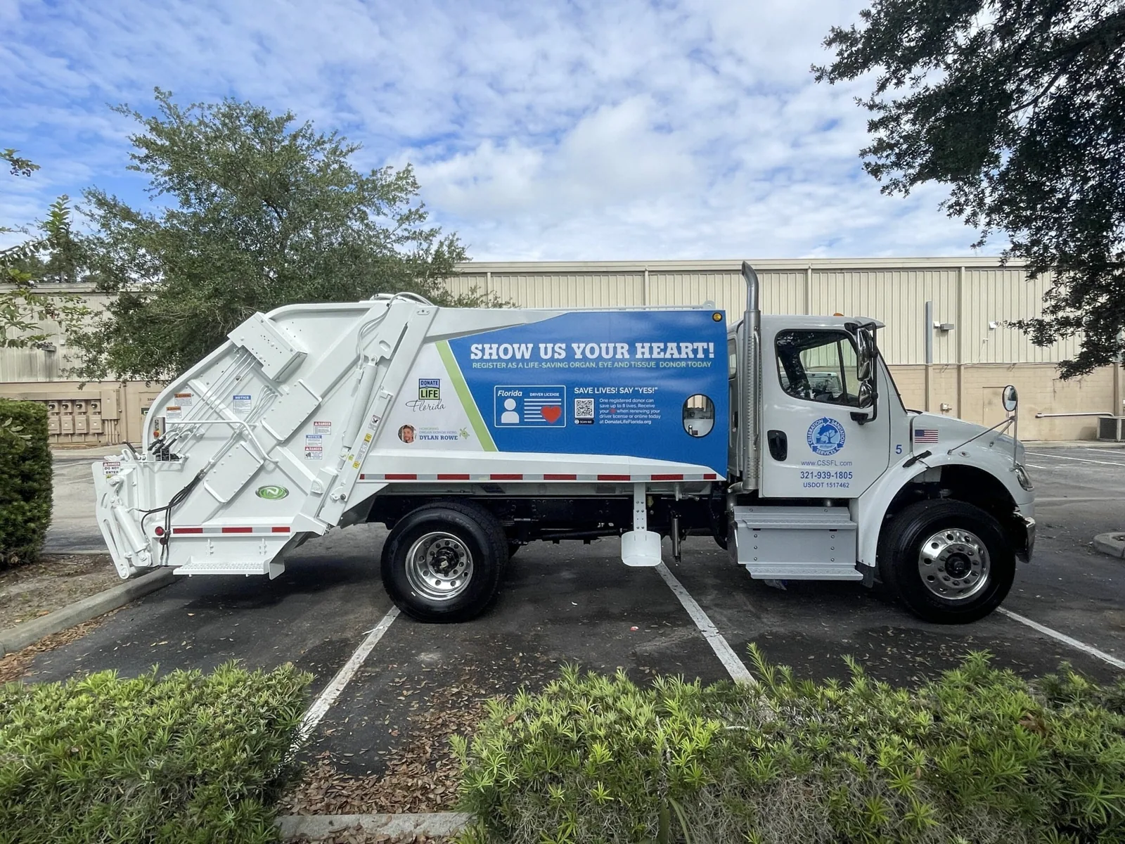 Garbage truck with a Show Us Your Heart! body wrap, Celebration Sanitation project
