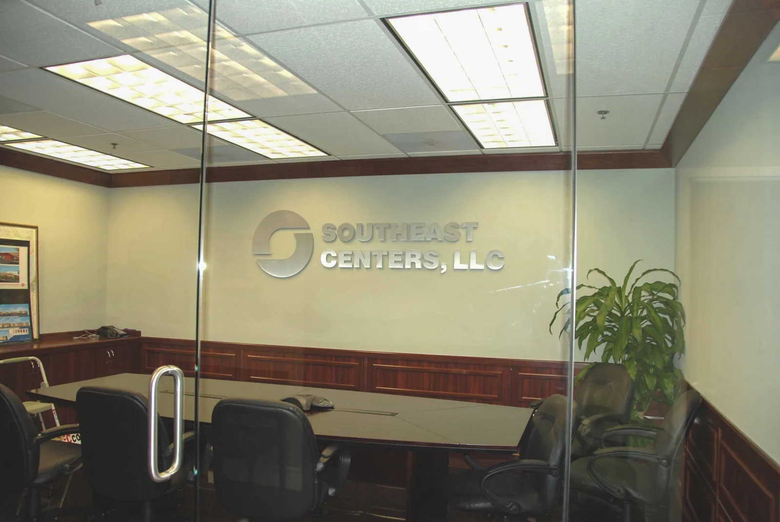 Frosted glass conference room wall with a Southeast Centers, LLC logo