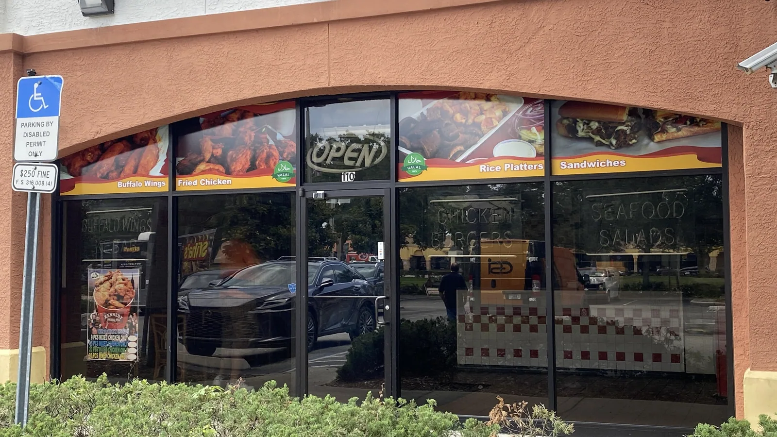 Restaurant storefront with printed food graphics along the top of the windows